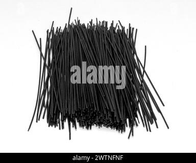 Healthy raw black rice noodles on white background Stock Photo