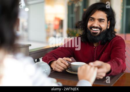 Millennial couple enjoying time together at coffee shop Stock Photo