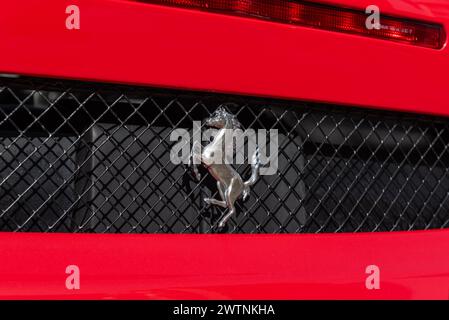 ISTANBUL, TURKEY - MARCH 13, 2024:  A close-up of the Ferrari logo on a red car with drops of water. The Scuderia Ferrari team was founded by Enzo Fer Stock Photo