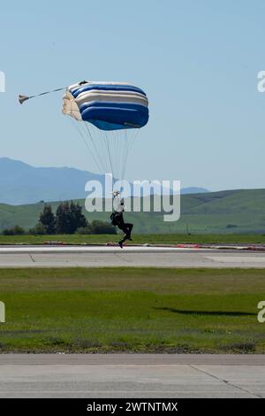 A  member of the U.S. Air Force Academy Wings of Blue Parachute Team lands during the Travis Air Force Base Wings Over Solano air show and open house at Travis AFB, California, March 16, 2024. The primary mission of the Wings of Blue is to run the U.S. Air Force Academy’s Basic Freefall Parachuting course, known as Airmanship 490. (U.S. Air Force photo by Kenneth Abbate) Stock Photo