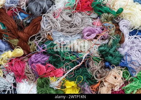A pile of tangled multi-colored threads, close-up, top view. Abstract background Stock Photo