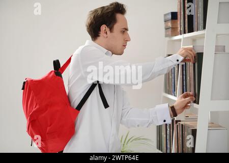 Male student choosing book in library Stock Photo