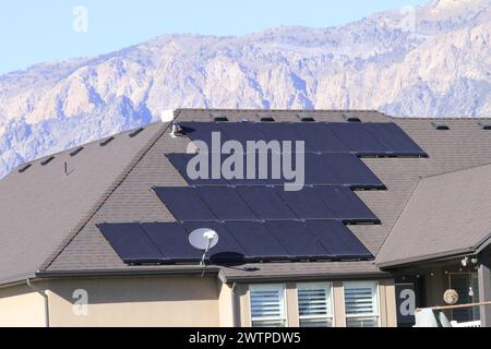 satellite Dish with solar panels on a roof Stock Photo