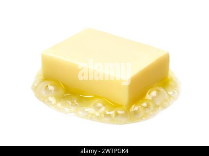 A piece of melting butter isolated on white background Stock Photo