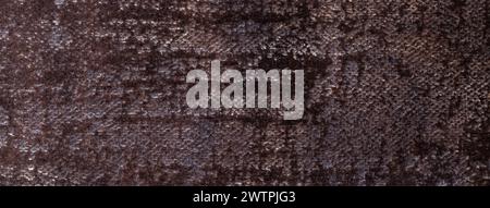 Dark brown fluffy background of soft, fleecy cloth. Texture of black textile backdrop with shiny pattern, closeup. Stock Photo