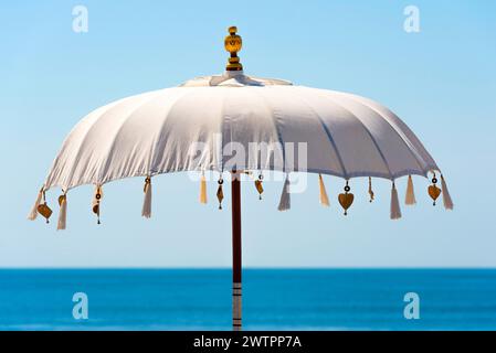 Traditional Balinese temple sunshade as parasol, sun, Hinduism, symbol, beach holiday, protection, sun protection, Balinese, culture, white, white Stock Photo