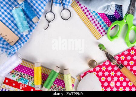 Sewing, needlework and clothing repair, background, scrapbooking, quilting. Colorful pieces of fabric, scissors, ruler, sewing tools, needles, threads Stock Photo
