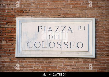 Piazza del Colosseo sign on a brick wall. Rome, Italy Stock Photo