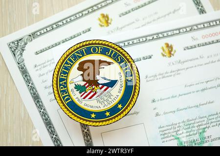 KYIV, UKRAINE - MARCH 9, 2024 US Department of Justice seal on certificate of naturalization close up Stock Photo