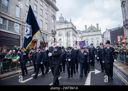 London, UK. 17th Mar, 2024. Police march during the St Patrick's Day Parade. The Mayor's annual celebration has become a highlight of London's cultural calendar as Londoners and visitors unite to celebrate the great contributions Irish people have made to the capital. St Patrick's Day is the ideal opportunity to pay homage to the enduring friendship between the British and Irish people. Credit: SOPA Images Limited/Alamy Live News Stock Photo