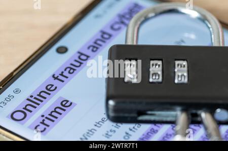 An online fraud and cyber crime security concept with a smart phone, combination padlock and the words online fraud and cyber crime Stock Photo