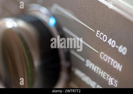 A energy saving, environmental concept with a washing machine setting on eco wash. Stock Photo