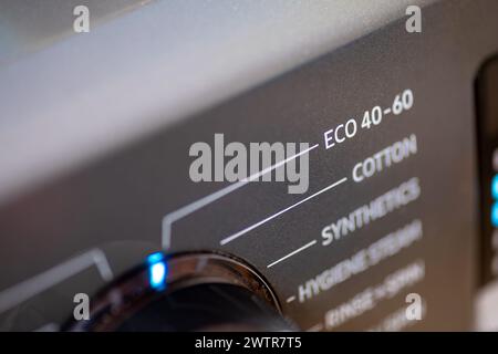 A energy saving, environmental concept with a washing machine setting on eco wash. Stock Photo