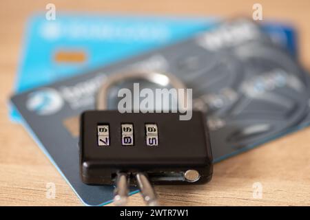 A credit, debit bank card security concept with a combination pad lock on top of bank cards. Stock Photo