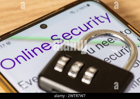 A macro closeup of a mobile phone with the words online security and a combination padlock on top. An online security concept. Stock Photo