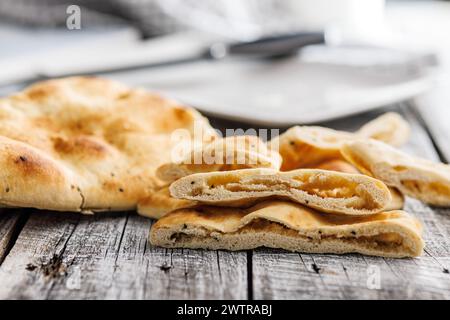 Freshly Baked Naan Bread on a wooden table Stock Photo
