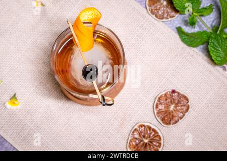 Top view of assorted liquor bottles and fresh fruits on a table Stock Photo