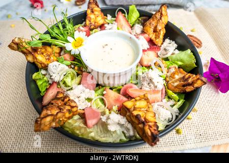 Fresh salad with chicken, lettuce, and tomatoes on a plate Stock Photo