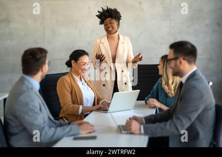 Team leader discussing and brainstorming new approaches and ideas with colleagues. Stock Photo