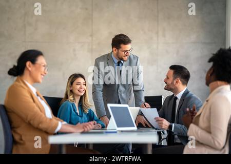 Group of multiethnic business people working together on teamwork meeting in corporate office. Stock Photo