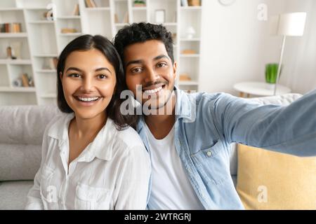 Happy indian couple taking selfie with cheerful expression Stock Photo
