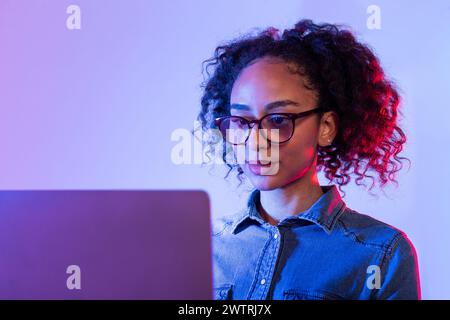 Focused young woman working on laptop Stock Photo