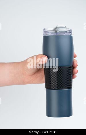 Blue metal flask in hand side view isolated on white studio background Stock Photo