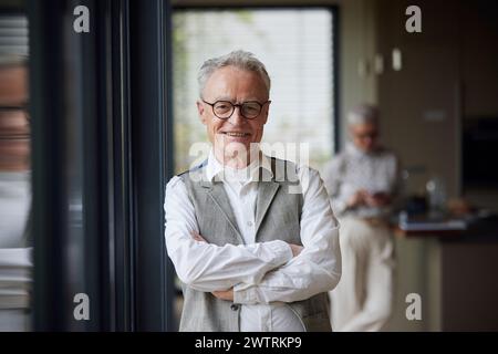 Portrait of confident senior man at home Stock Photo
