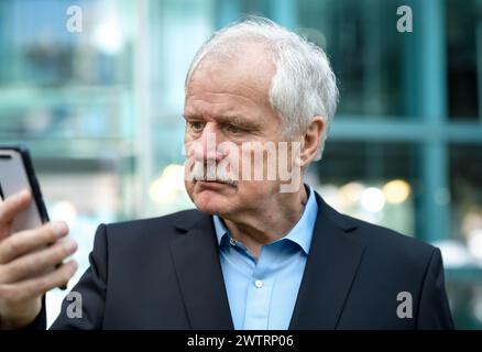 Senior Business man looking concerned at his mobile phone. Stock Photo