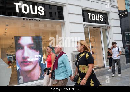 Pedestrians and shoppers walk past the Spanish jewelry, accessories, and fashion retailer Tous store in Spain. Stock Photo