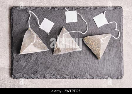 Triangular teabag with tea on a slate Stock Photo