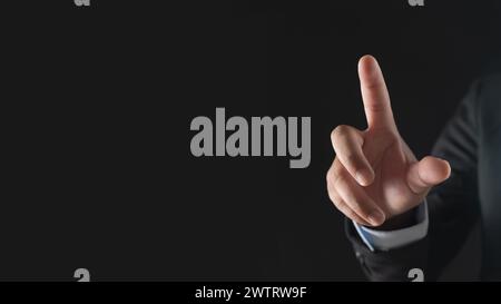 Businessman hand touching virtual screen on black background with blank for copy space Stock Photo