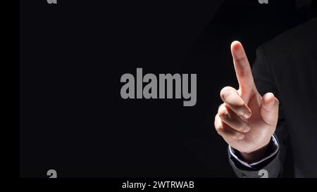Businessman hand touching virtual screen on black background with blank for copy space Stock Photo