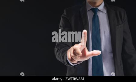 Businessman hand touching virtual screen on black background with blank for copy space Stock Photo