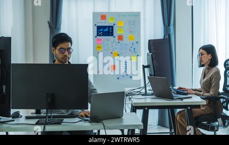 asian woman  and Indian man Developer team working  about programming software data online at office Stock Photo