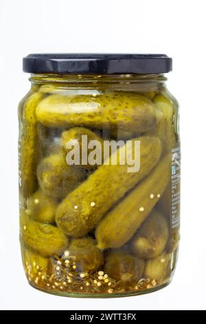 A glass jar of whole pickled gherkins Stock Photo