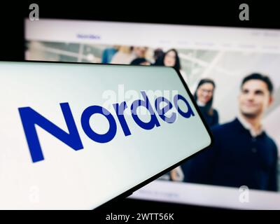 Mobile phone with logo of Finnish financial services company Nordea Bank Abp in front of website. Focus on center-right of phone display. Stock Photo