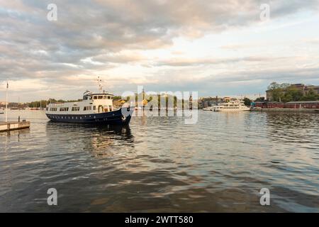 Boats in Stockholm Nybro with Skeppsholmen island in the background Stock Photo