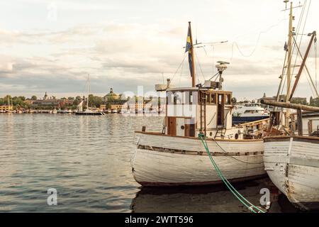 Boats in Stockholm Nybro with Skeppsholmen island in the background Stock Photo