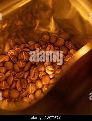 Roasted coffee beans in a brown bag on a table Stock Photo