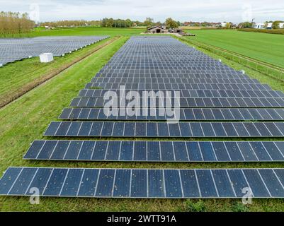 Expansive solar farm under a cloudy sky Stock Photo