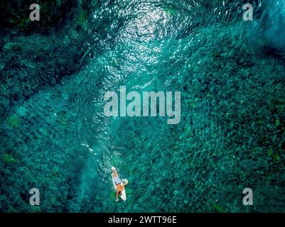 Surfers are surfing the waves. Nusa Lembongan is an island southeast of Bali with beautiful beaches. aerial view Stock Photo
