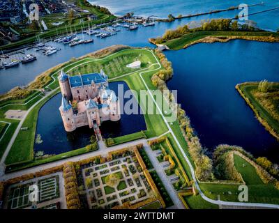 Aerial view of a majestic castle surrounded by a serene moat at dusk ...