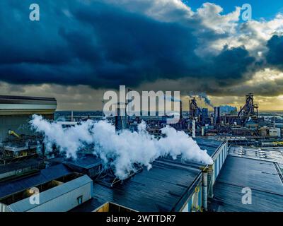 Industrial landscape under a dramatic cloudy sky at dusk. Stock Photo