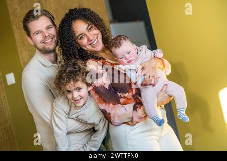 Happy family posing for a cozy portrait at home. Stock Photo