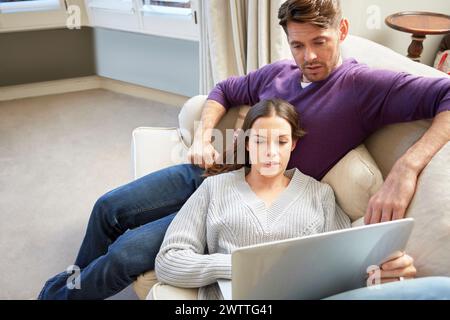 Couple on sofa using a tablet Stock Photo
