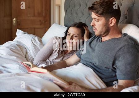 Couple reading in bed Stock Photo