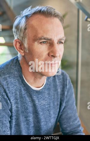 Portrait of a pensive man by a window Stock Photo