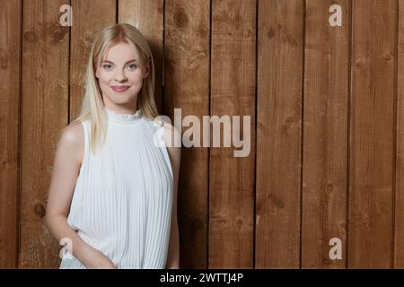Woman standing in front of wooden planks. Stock Photo