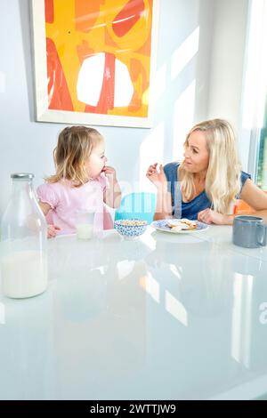Mother and daughter having breakfast together Stock Photo